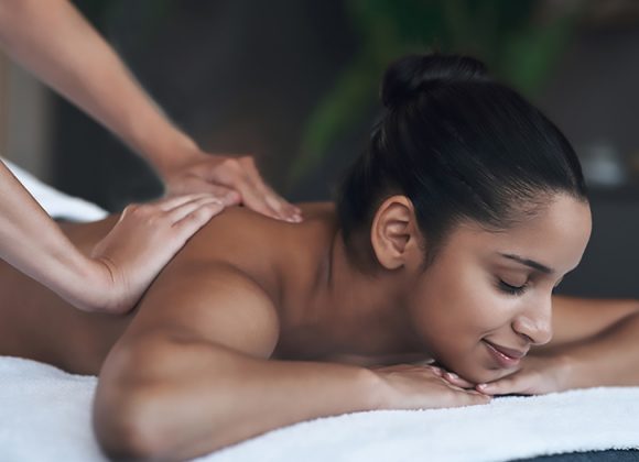 Shot of a young woman getting a back massage at a spa.