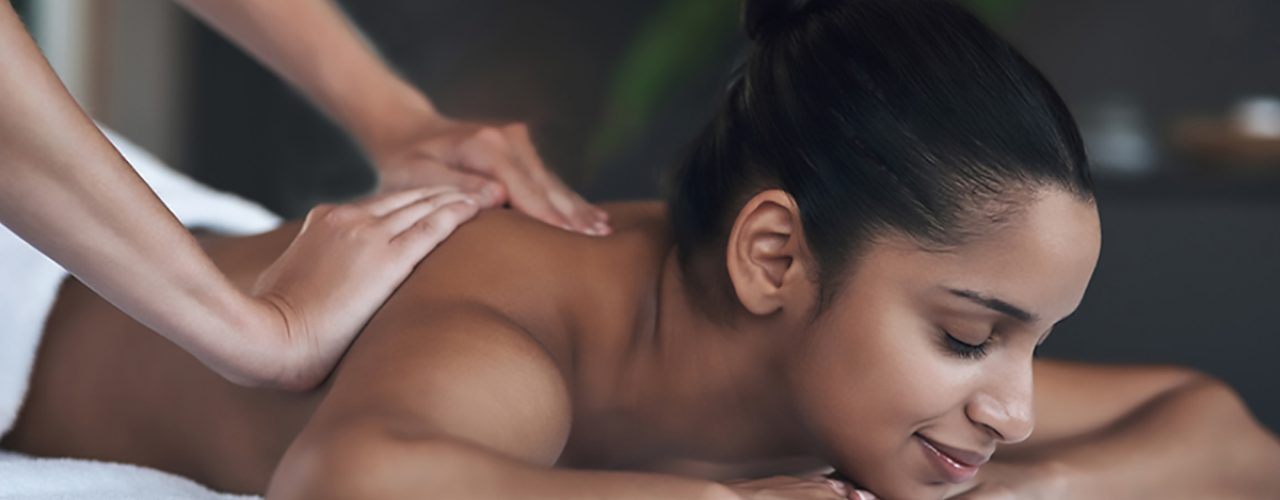 Shot of a young woman getting a back massage at a spa.