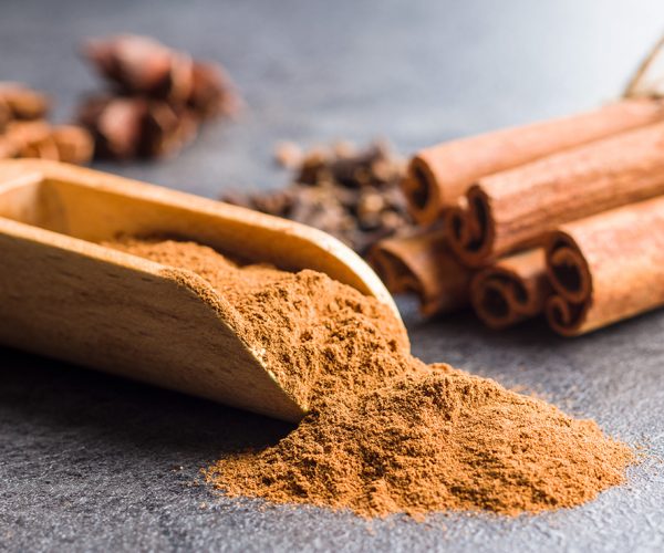 Cinnamon sticks and milled cinnamon spice on old table.