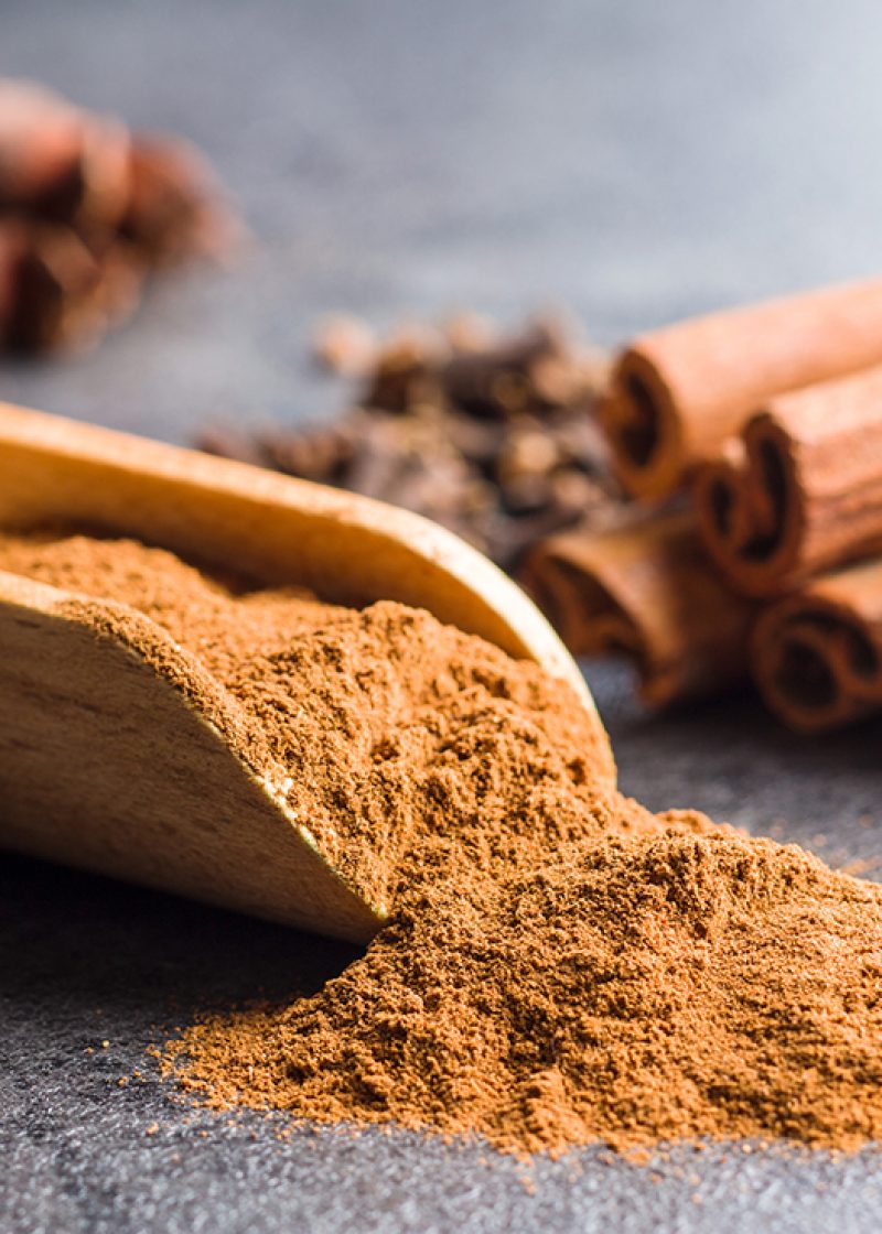 Cinnamon sticks and milled cinnamon spice on old table.