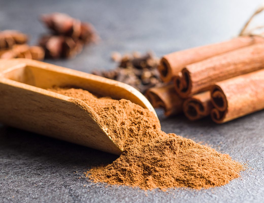Cinnamon sticks and milled cinnamon spice on old table.