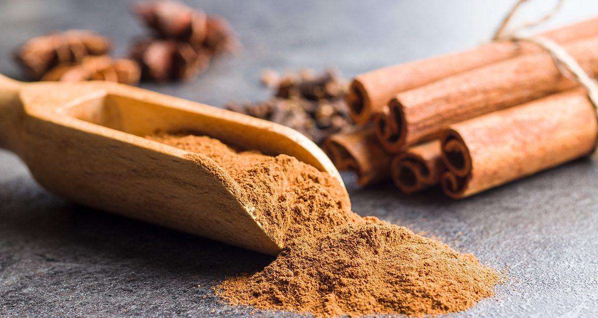 Cinnamon sticks and milled cinnamon spice on old table.