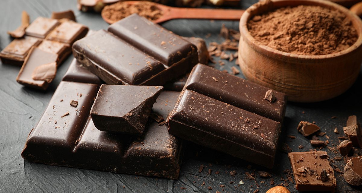 Chocolate, melted chocolate and almond on black background