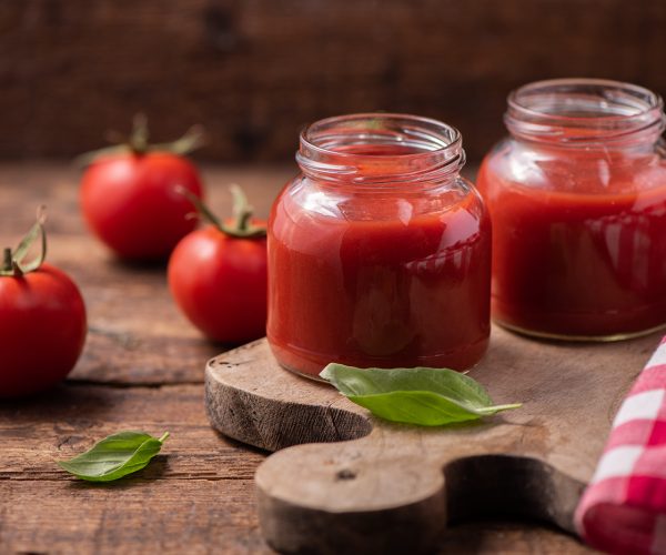 Traditional homemade tomato sauce and tomatoes. Close up