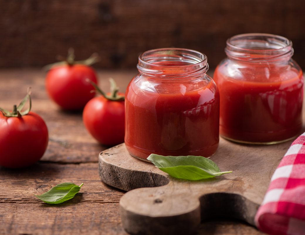 Traditional homemade tomato sauce and tomatoes. Close up