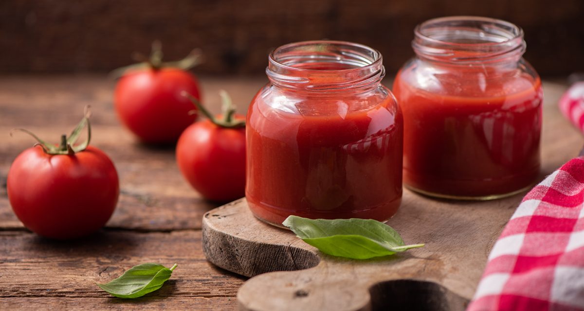 Traditional homemade tomato sauce and tomatoes. Close up