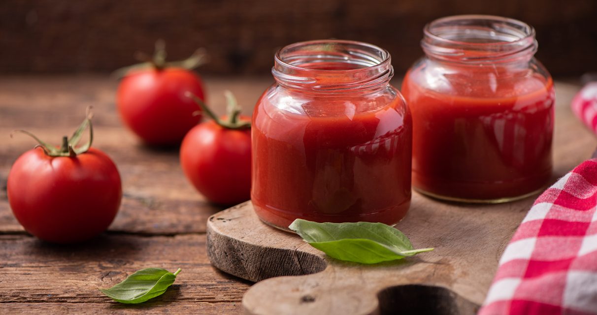 Traditional homemade tomato sauce and tomatoes. Close up