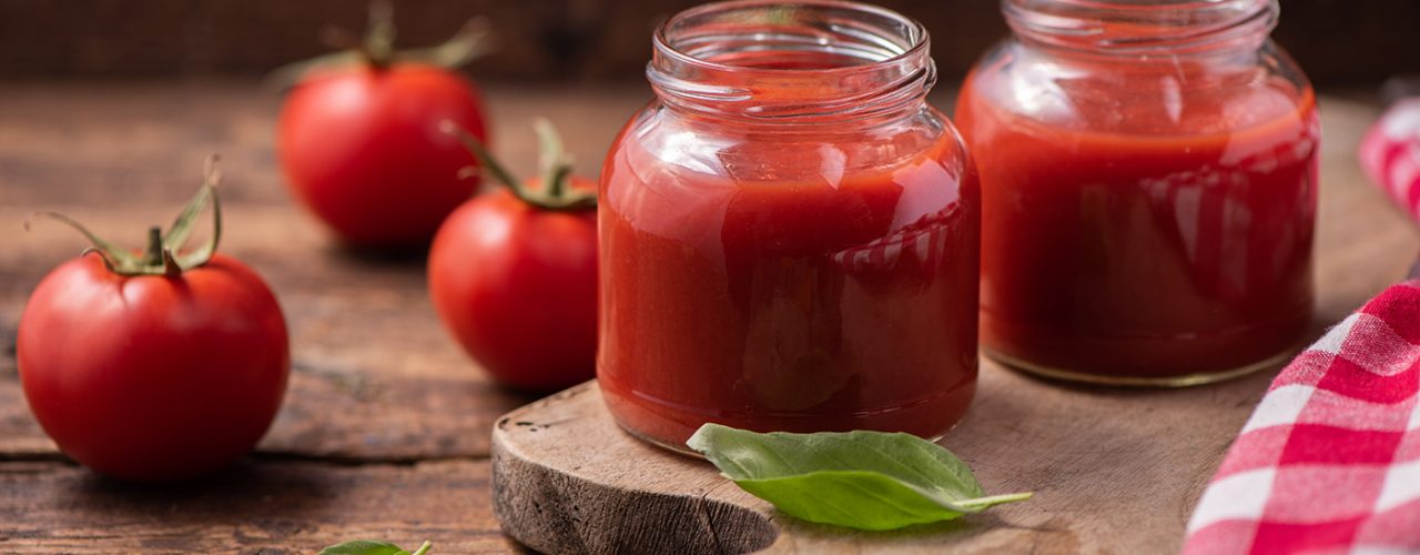 Traditional homemade tomato sauce and tomatoes. Close up